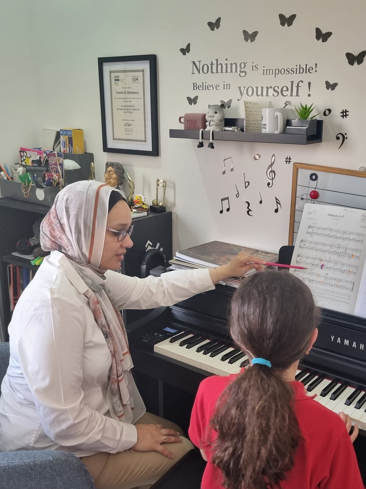 Yasmin Shennawy teaching a young student at the piano in her studio